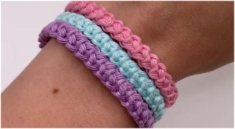 two different colored crocheted bracelets on someone's arm, one is blue ...