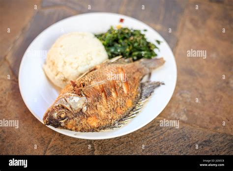 Traditional East African food - ugali, fish and greens in Kenya Stock Photo: 147638520 - Alamy