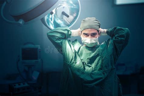 Male Surgeon Tying Face Mask at Operating Room Stock Image - Image of hospital, asian: 56872553