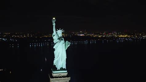 5.5K stock footage aerial video of the front of the Statue of Liberty at Night in New York ...