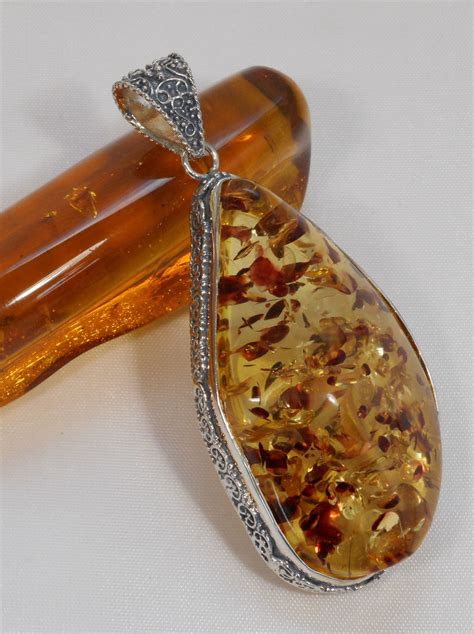 Striking large translucent highly-polished free-form Amber gemstone is bezel-set in 925 sterling ...