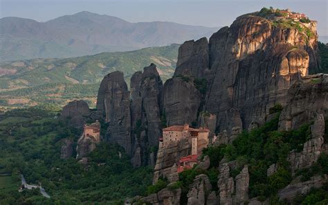 Roussanou, St. Nicholas Anapafsas and Great Meteoron Monasteries at sunrise. Meteora, Thessaly ...