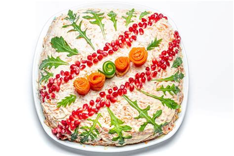 Fish and vegetable salad decorated with fresh herbs, olives and caviar ...