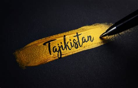 Premium Photo | Tajikistan handwriting text on golden paint brush stroke