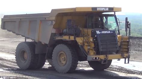 Cat 775F in action - Caterpillar Muldenkipper - Rigid Dump Truck - YouTube