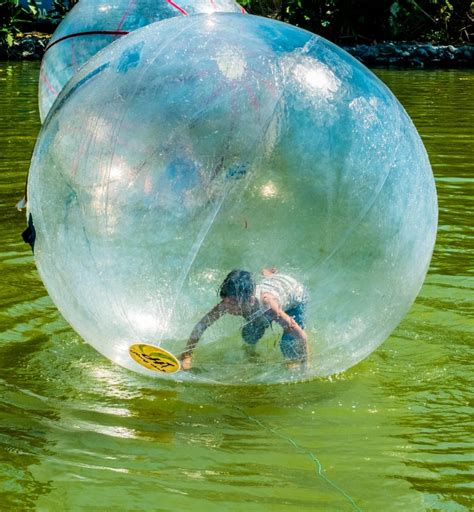 boy inside bubble on top of water photo during daytime free image | Peakpx
