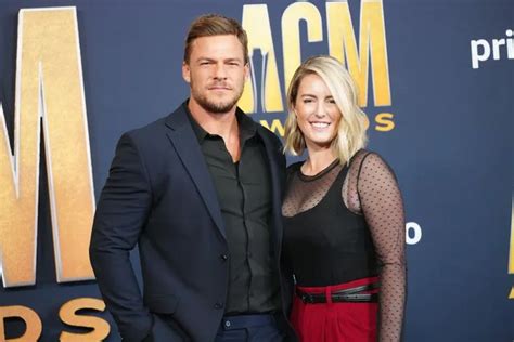 a man and woman standing next to each other on a red carpet