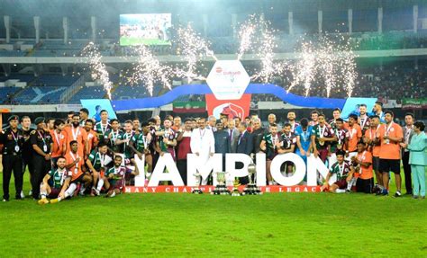 Mohun Bagan Super Giant players pose for photos with the trophy after ...