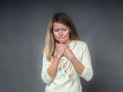 Woman with Hands on His Chest Sorrowfully with Regret and Sorrow Looking Down. Brunette with Sad ...