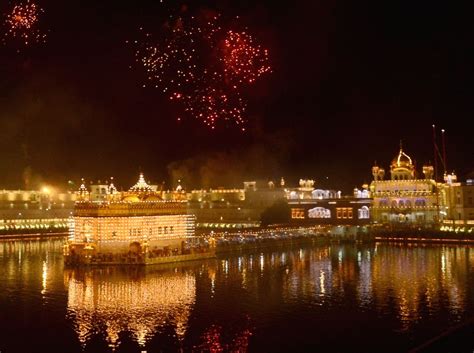 Devotees watch fireworks explode over the illuminated Golden Temple.