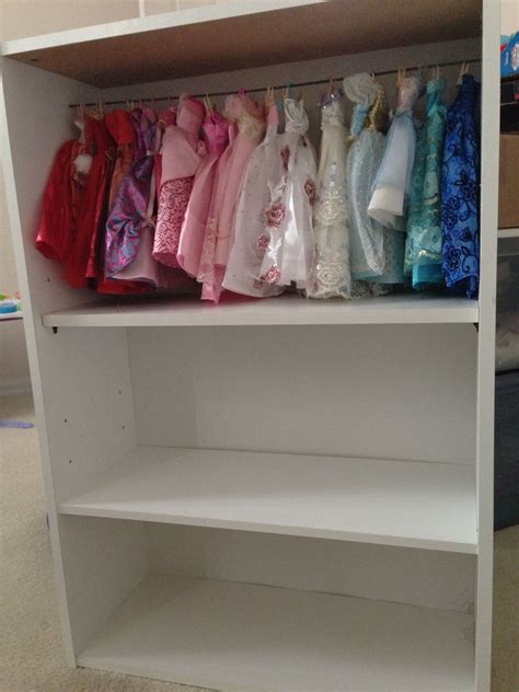 DIY Barbie closet using bookshelves - the bar is installed on the top floor,it's bowing a little ...