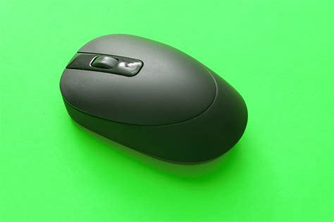 Free Stock Photo 10800 Black Cordless Computer Mouse on Green Background | freeimageslive