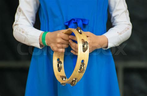 Girl with a tambourine performing on stage. | Stock image | Colourbox