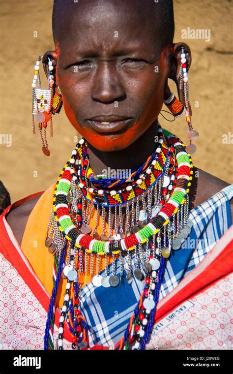 Portrait of a Maasai Woman wearing traditional clothing and jewelry ...