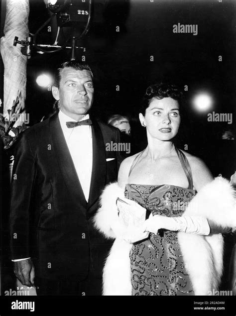 RICHARD EGAN with his wife actress PATRICIA HARDY circa 1958 candid at movie opening publicity ...