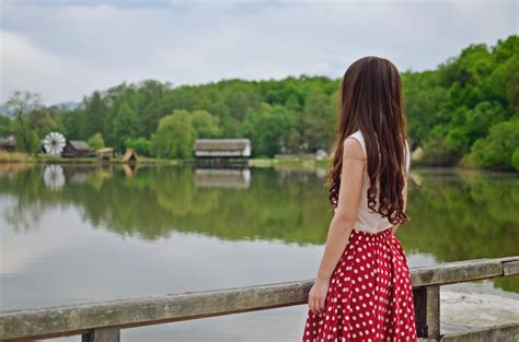 Young Woman Leaning Against a Tree · Free Stock Photo