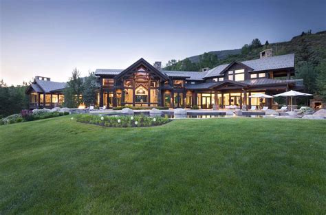 a large house sitting on top of a lush green field