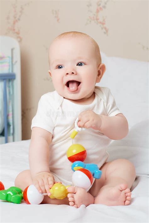 Cute Smiling Baby Laughing and Smiling with a Toy in His Hand. L Stock Photo - Image of ...