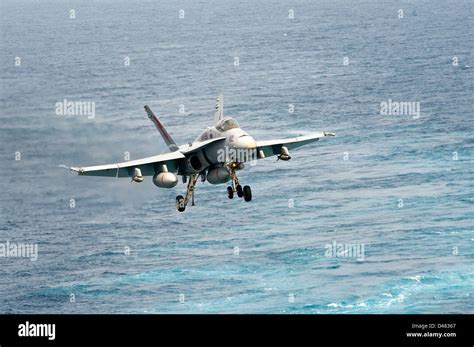 F/A-18 Hornet approaches aircraft carrier Stock Photo - Alamy