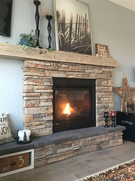 Rustic stone fireplace with asymmetric mantel and hearth. | Rustic stone fireplace, Rustic stone ...