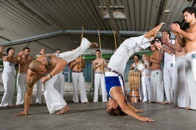 a group of men standing around each other on top of a dance floor in ...