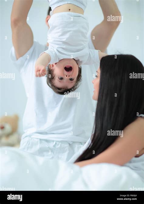 Happy parents playing with their child Stock Photo - Alamy