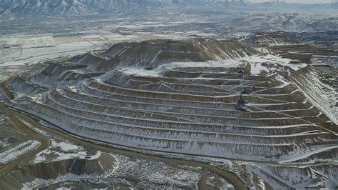 5.5K stock footage aerial video of orbiting the side of the Bingham Canyon Mine with light ...