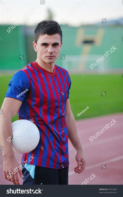 Portrait Of Young Handsome Soccer Player Man At Football Stadium And ...