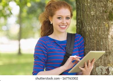 Smiling Student Leaning Against Tree Using Stock Photo 167763302 | Shutterstock