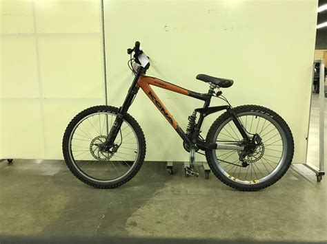 ORANGE AND BLACK KONA STINKY FULL SUSPENSION 21 SPEED MOUNTAIN BIKE