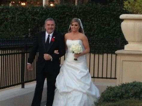 a bride and groom walking down the street