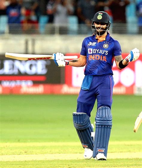 :Dubai:India's Virat Kohli celebrates after scoring a century.