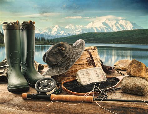 Fly fishing equipment on deck with view of a lake and mountains