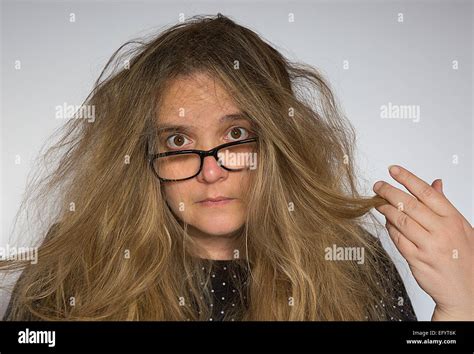 Middle-age woman pulling her messed up hair and looking sad Stock Photo ...