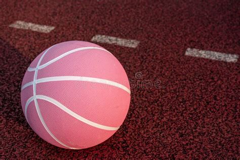 Pink Basketball Ball on the Ground. Close-up Ball on the Red Court. Basketball on the Street or ...