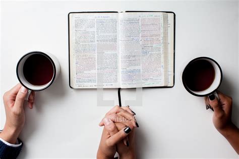 Couple praying together with an open bible and... — Photo — Lightstock