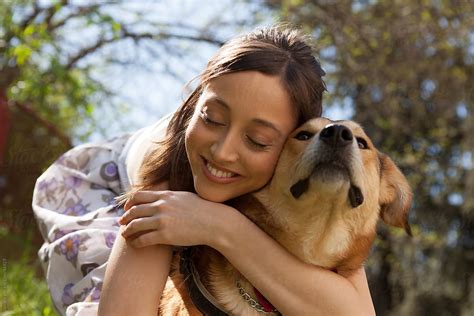 "Woman Hugging Her Dog" by Stocksy Contributor "Lumina" - Stocksy