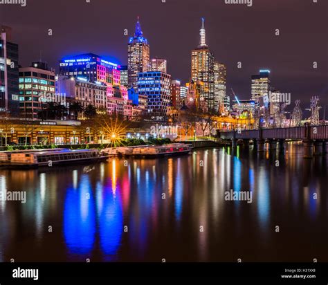 Skyscrapers lit up at night in a city, Central Business District, Melbourne City Centre ...