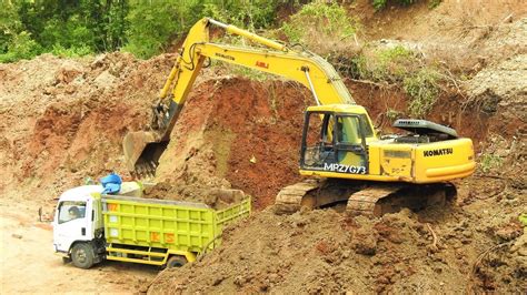 Excavator Digging And Clearing Landslide Dirt Into Dump Trucks - YouTube