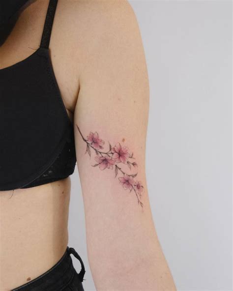 Cherry blossom tattoo located on the inner arm.