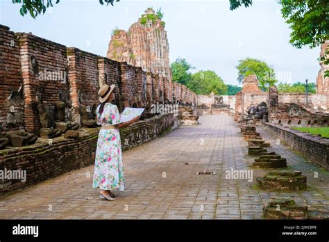 Ayutthaya, Thailand at Wat Mahathat, women with a hat and tourist maps ...