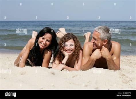 Friendly people lying on sandy beach Stock Photo - Alamy