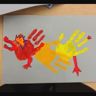 a child's handprint is shown on a piece of paper with an image of a fish