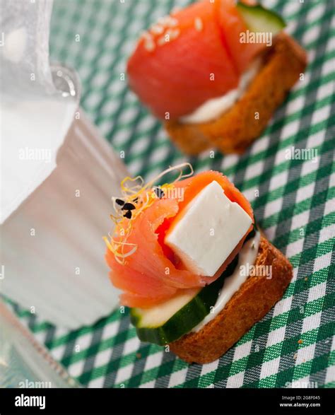 Canape with salmon, young soft cheese, cucumber Stock Photo - Alamy