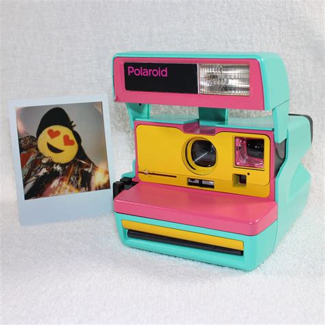 Yellow Polaroid Camera / The camera signals the recommended aperture setting with a flashing led ...