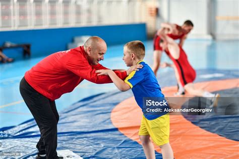 Child Learning The Basics Of Stance And Motion With Wrestling Coach ...