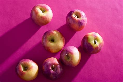 Free Image of Apples lying on purple background | Freebie.Photography