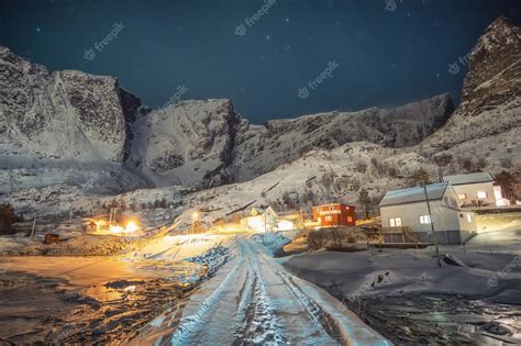 Premium Photo | Norwegian colorful village surrounded snow mountain ...