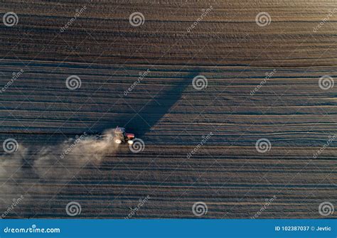 Tractor harrowing soil stock image. Image of industry - 102387037