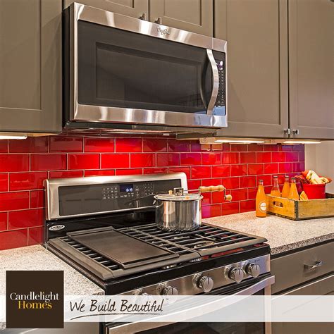 Get things cooking with a fiery red backsplash! #CandlelightHomes #utahhomes #utahbuilder # ...